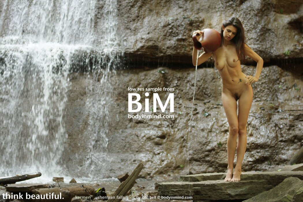 NAKED GIRL UNDER A WATERFALL