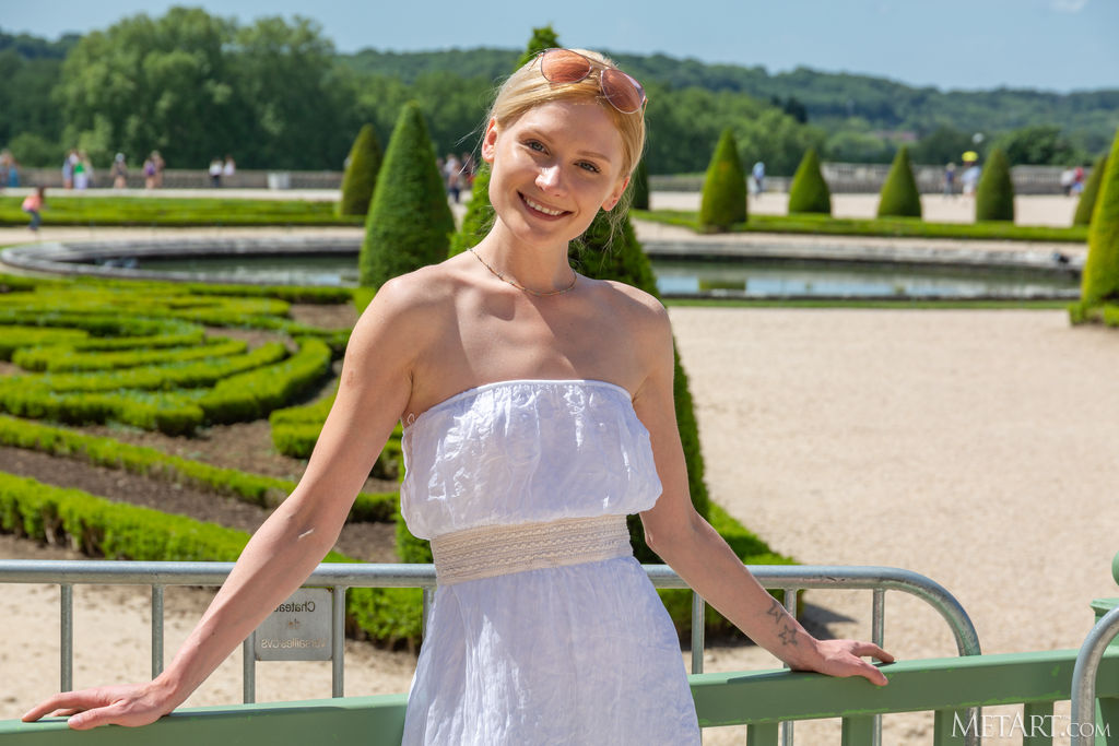 Gerda Rubia Pulls Down The Top Of Her Dress To Bare Her Beautiful Breasts