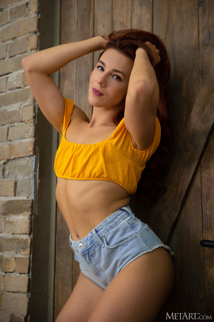 Sexy Redhead Oxi Bendini Kicks Her Long Legs Wide