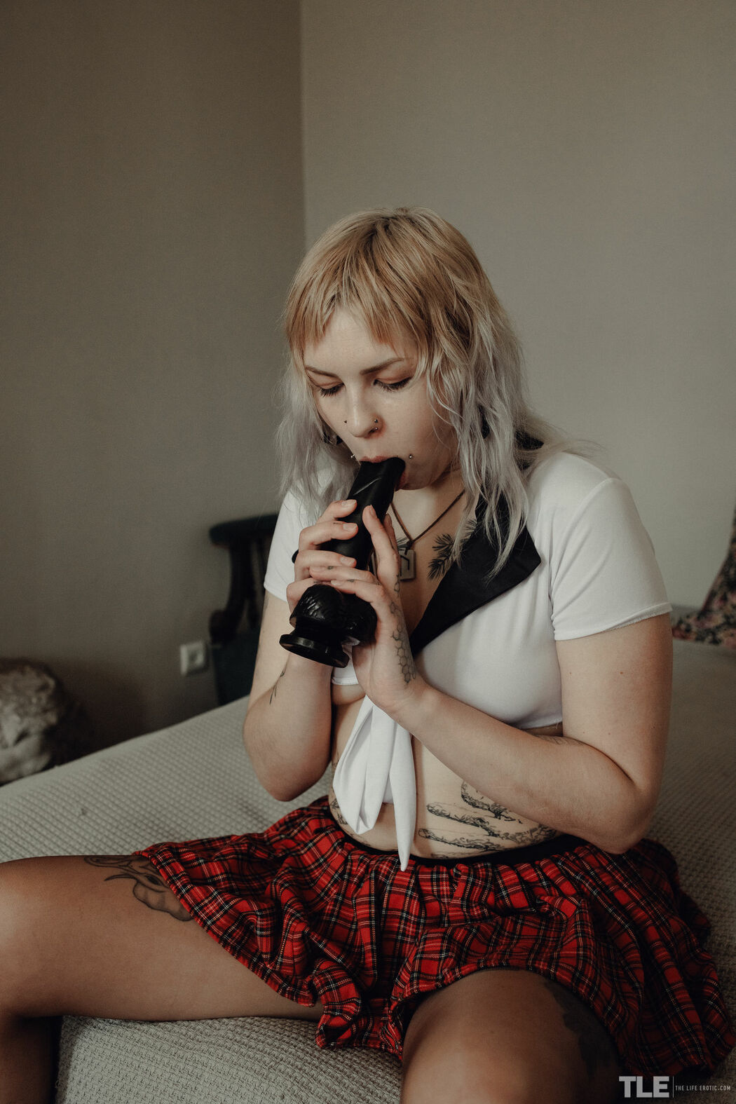 Sem Retlick Grabs Her Ass Enticingly In A Plaid Skirt And Black Pantyhose